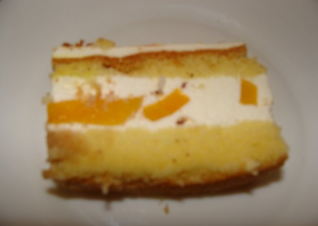 Fotografia przedstawiająca ciasto biszkoptowe z brzoskwiniami