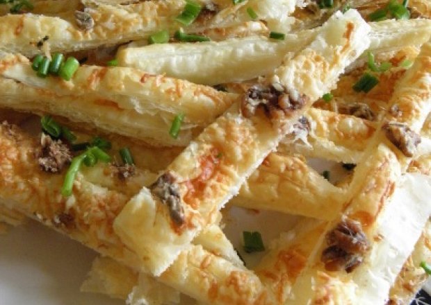 Fotografia przedstawiająca Finger food - paluszki z ciasta francuskiego z kozim serem i anchois
