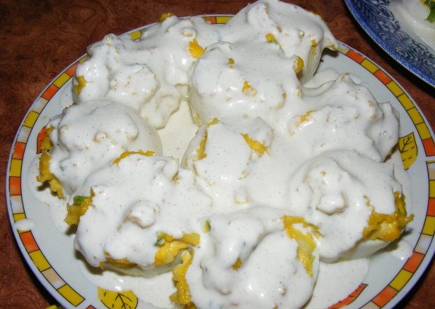 Fotografia przedstawiająca Jajka faszerowane serem zółtym z sosem śmietanowym