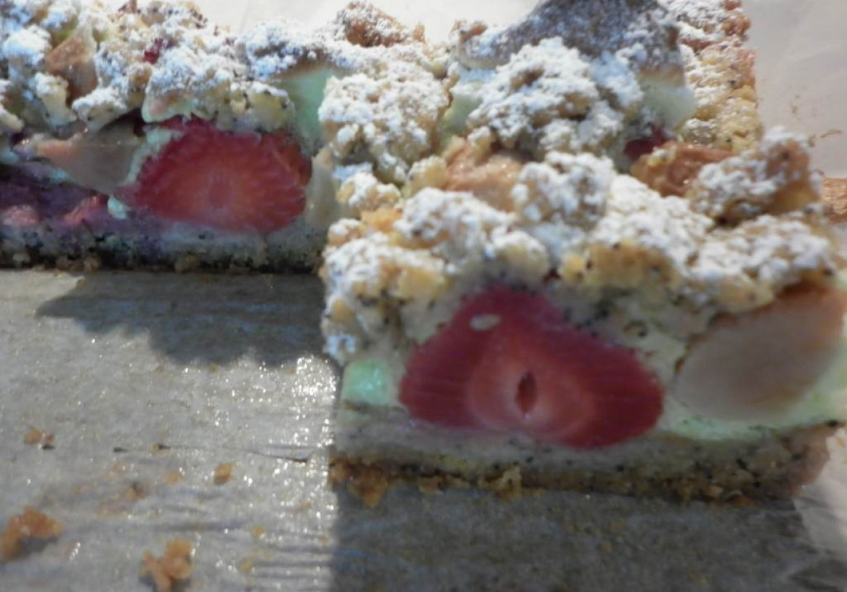 Makowe kruche ciasto z truskawkami i gruszką w zielonej piance foto