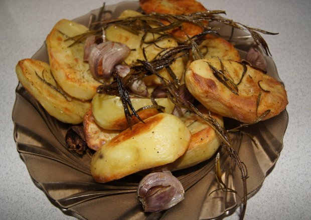 Fotografia przedstawiająca Pieczone ziemniaki z czosnkiem i świeżym rozmarynem