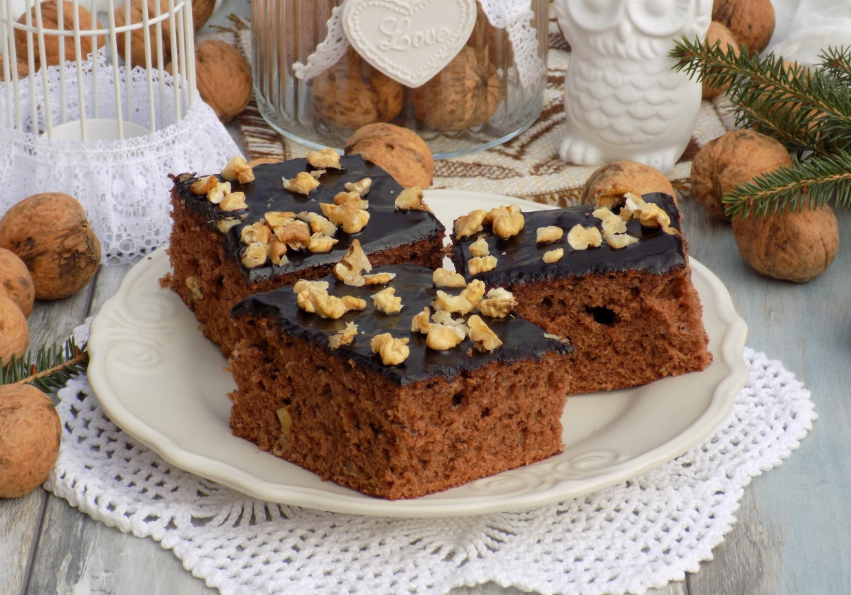 Piernikowo-miodowe ciasto z polewą czekoladową i orzechami. foto