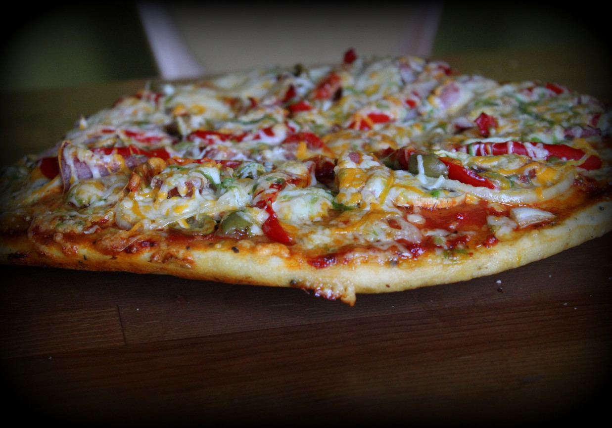 Pizza serowa z polędwicą, papryką i oliwkami foto