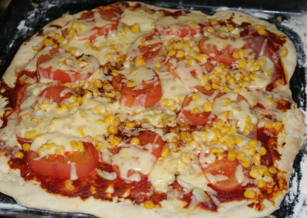 Fotografia przedstawiająca Pizza z pomidorami i szynką