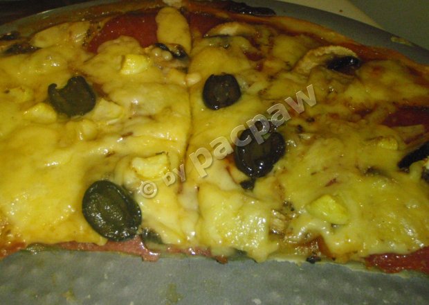 Fotografia przedstawiająca Pizza z salami i czarnymi oliwkami
