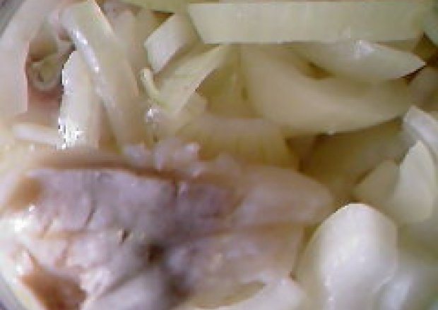 Fotografia przedstawiająca śledzie w oleju z cebulą