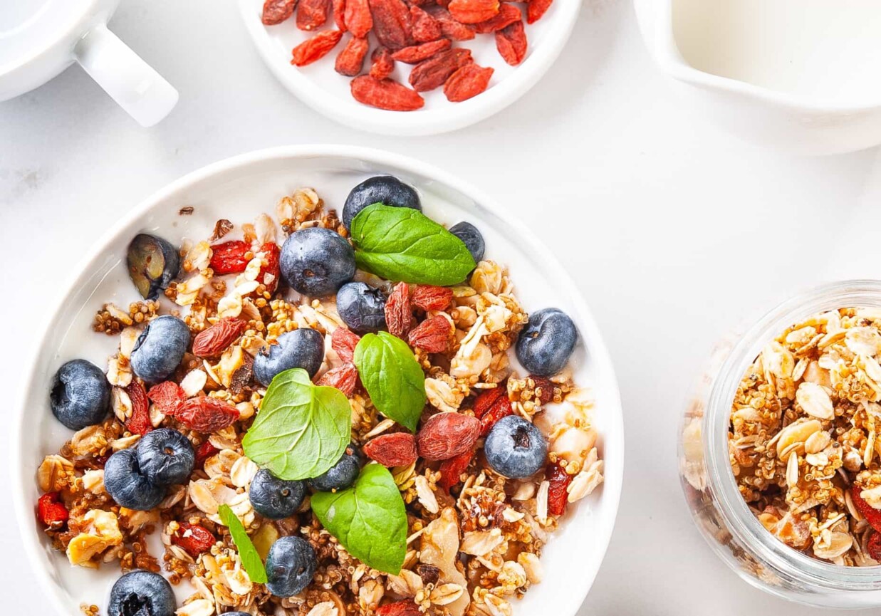 Śniadanie: Granola z komosy ryżowej, płatków owsianych i orzechów z jogurtem, borówkami i jagodami goji foto