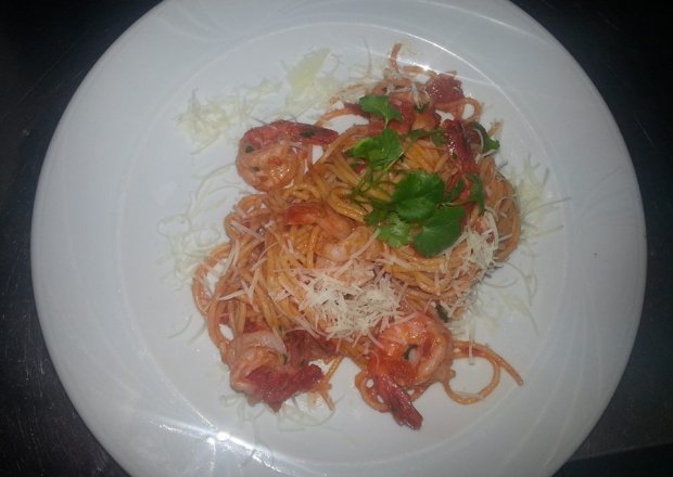 Fotografia przedstawiająca Spaghetti z krewetkami, papryką chilli i parmezanem.