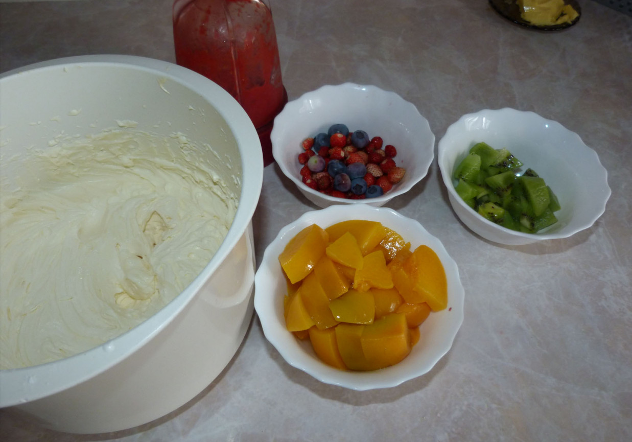 tęczowe lody z owocami i bitą śmietaną z polewą truskawkową foto