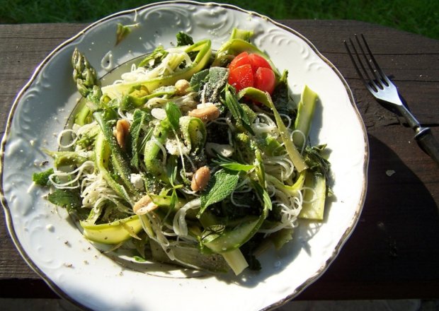 Fotografia przedstawiająca zielone warzywa z makaronem ryżowym i śwżymi ziołami